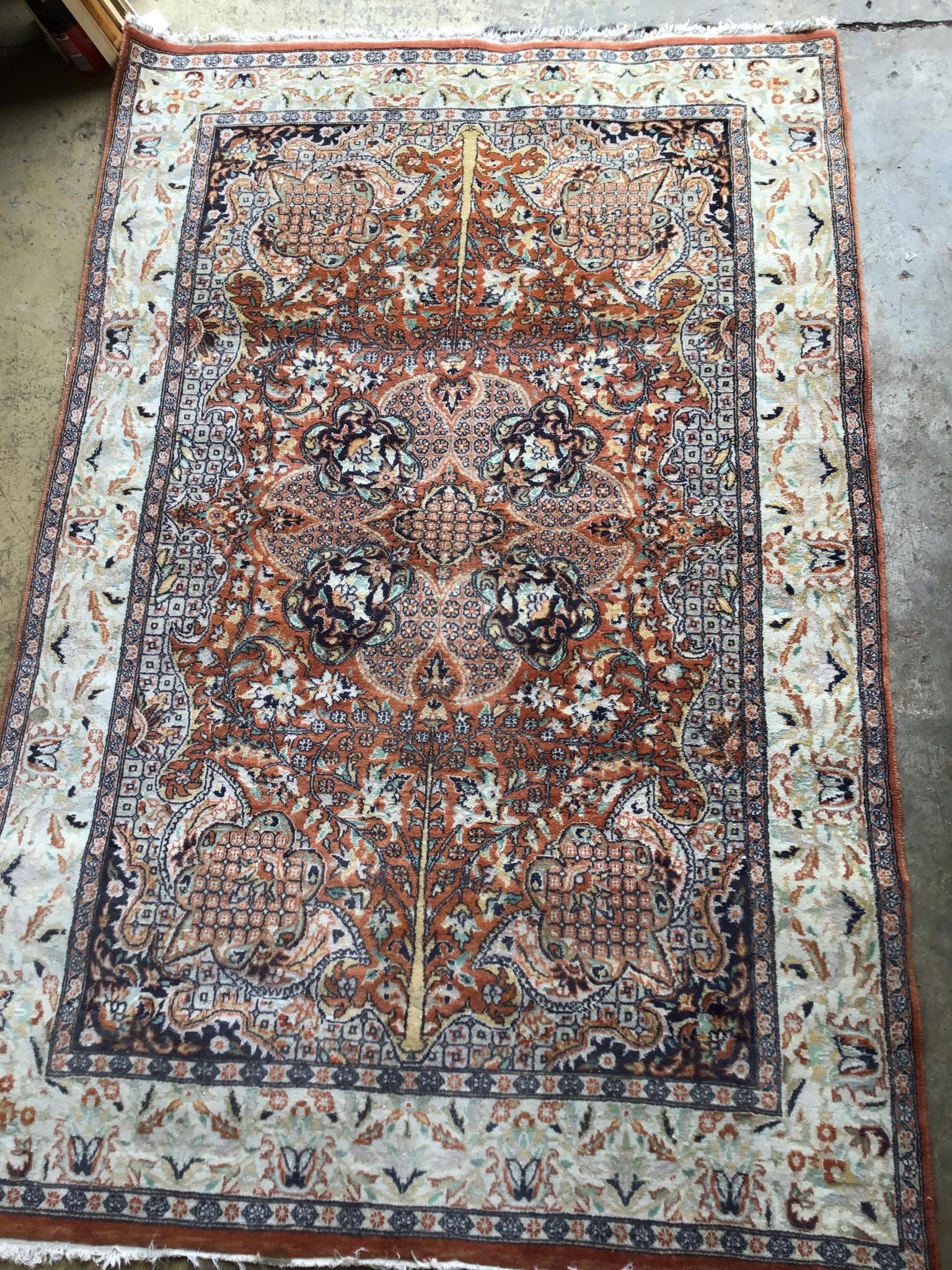 A North West Persian style brick red ground rug, 190 x 126cm